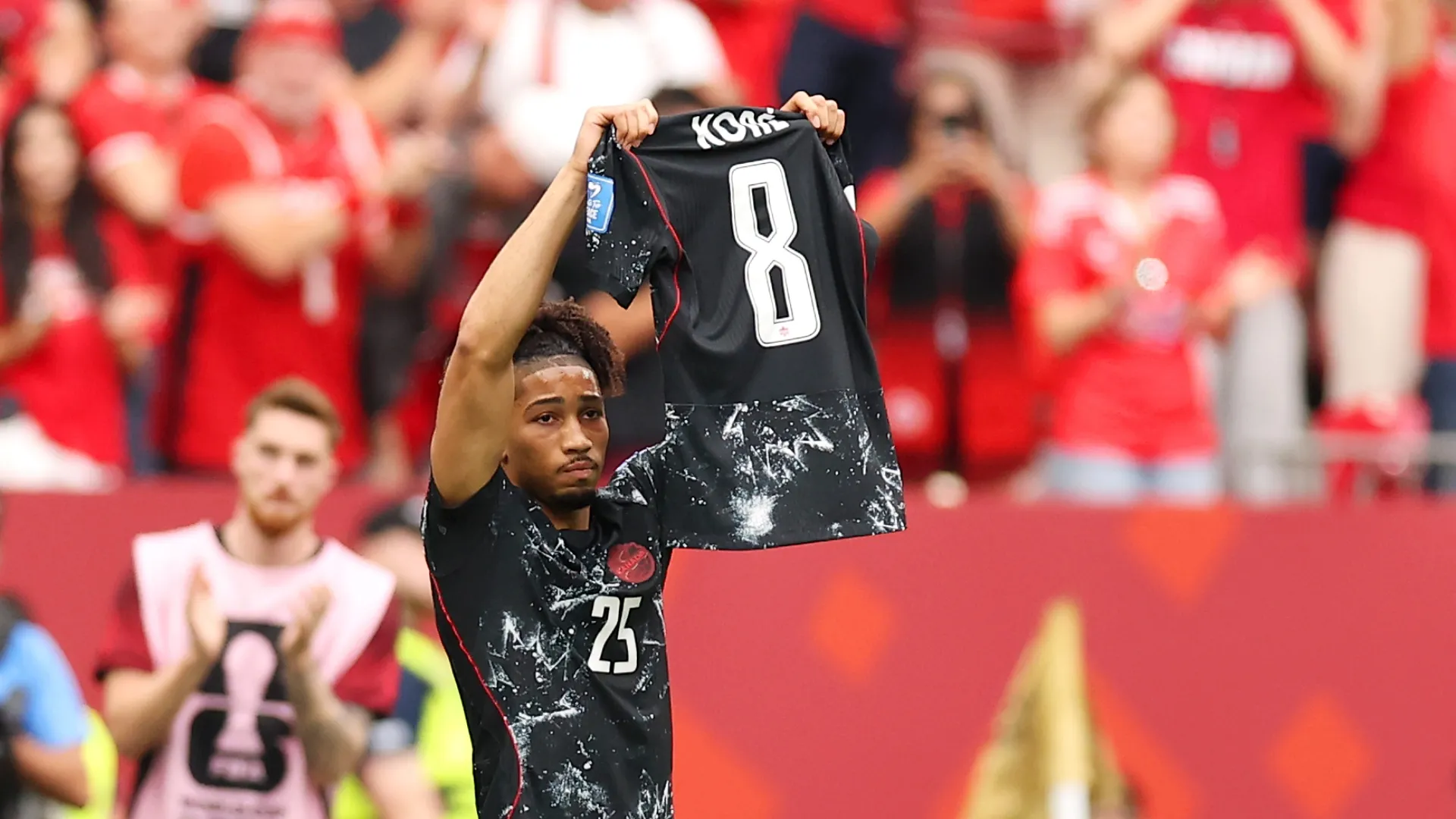 Nathan Saliba holds Ismael Kone’s jersey up in the Vancouver sky.