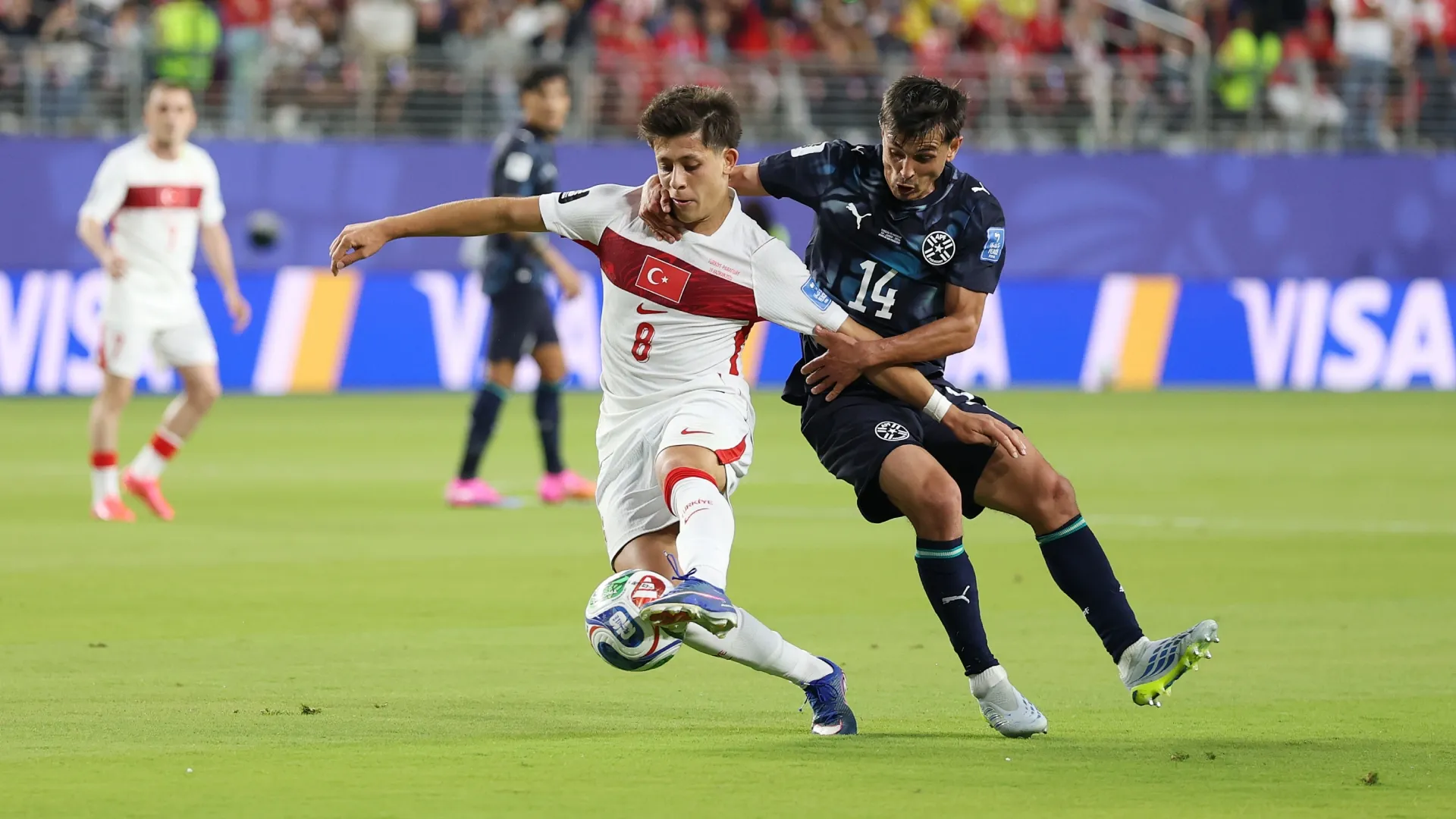 Arda Guler #8 of Turkiye is challenged by Andres Cubas #14 of Paraguay