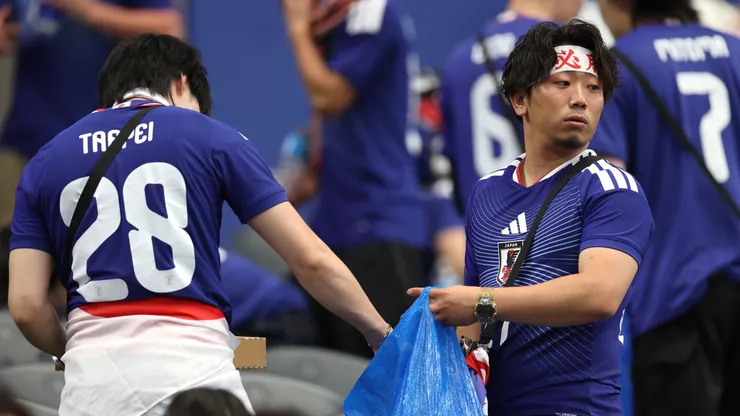 Japan fans clear trash in the stands during the World Cup 2026