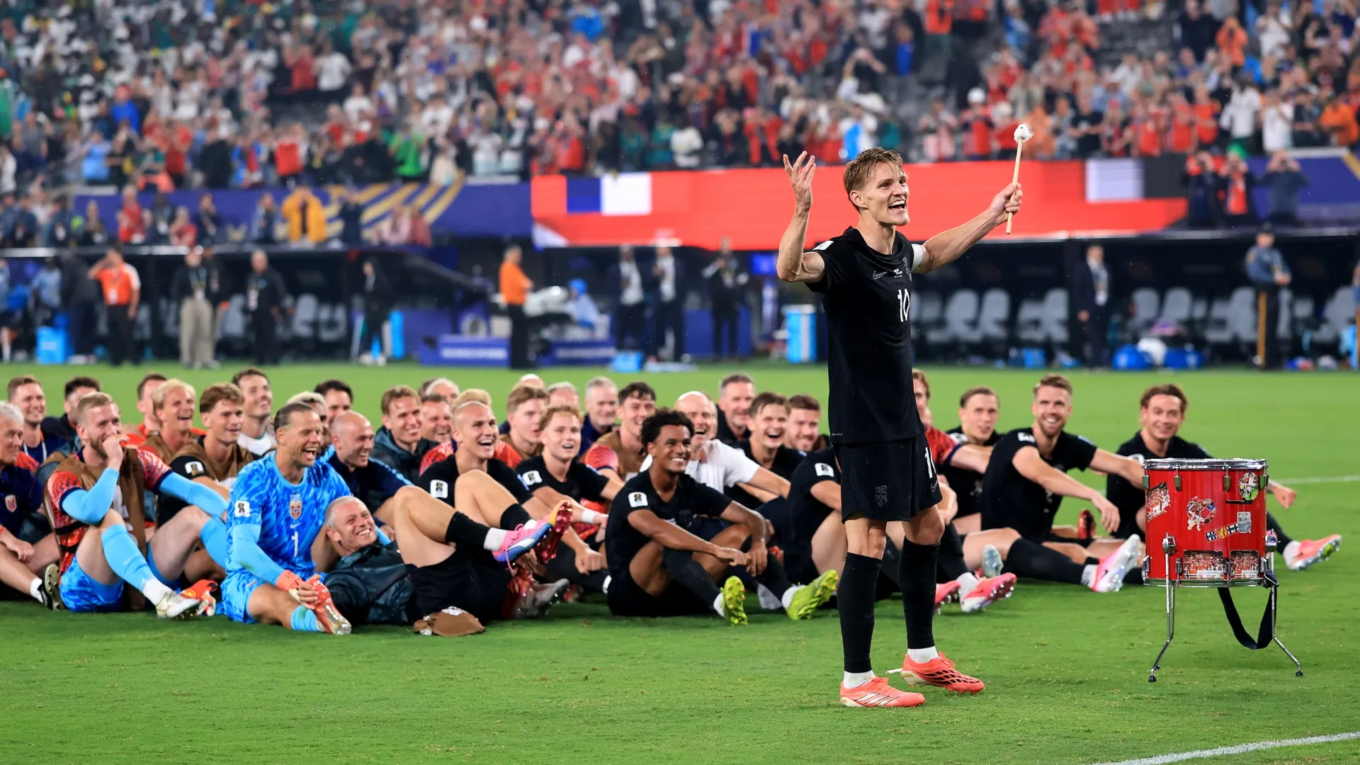 Martin Odegaard #10 of Norway and teammates celebrate with fans. Buda Mendes/Getty Images