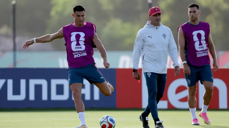 Cristiano Ronaldo #7 kicks the ball next to head coach Roberto Martinez.