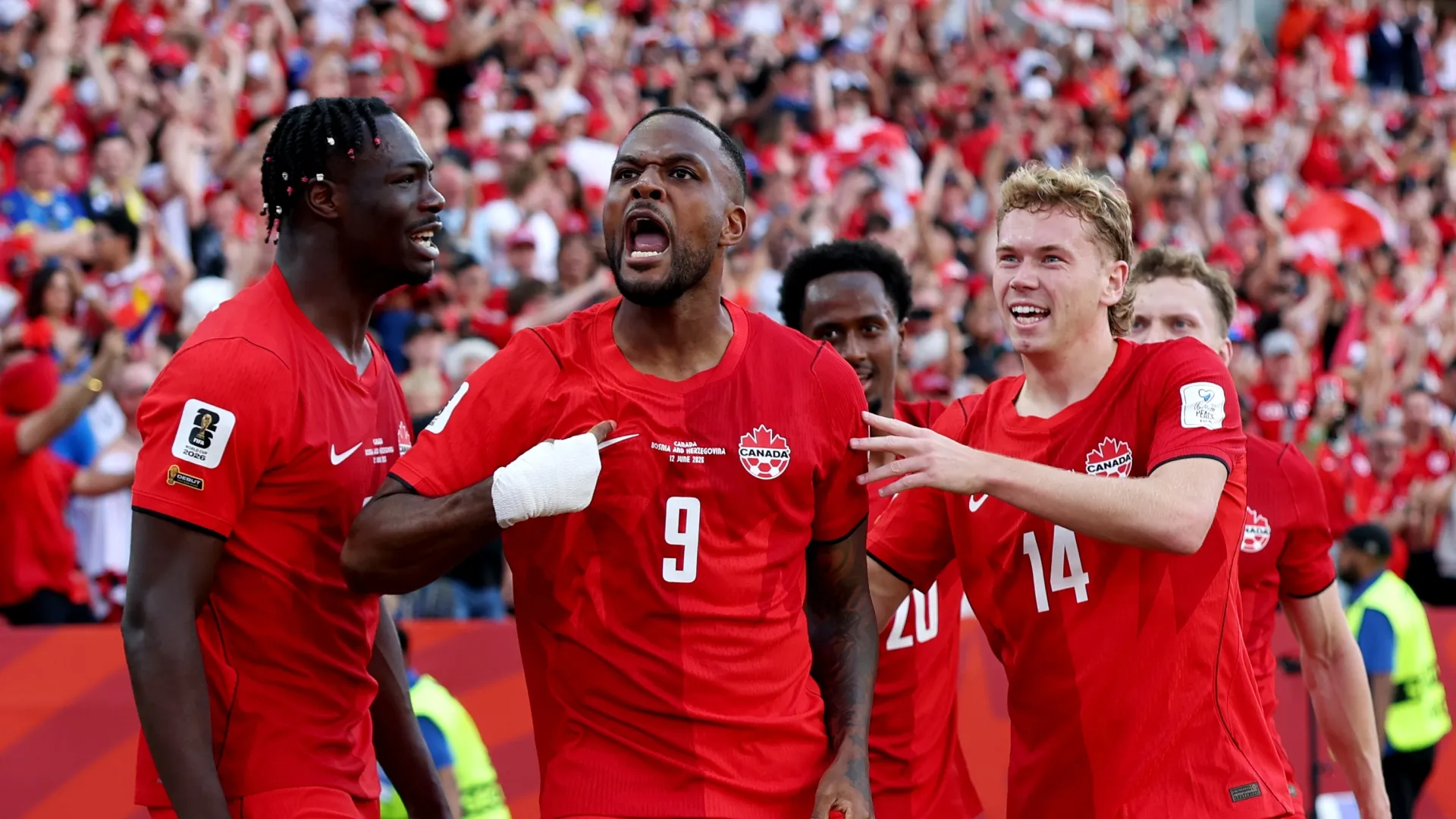 Cyle Larin and Canada celebrating.