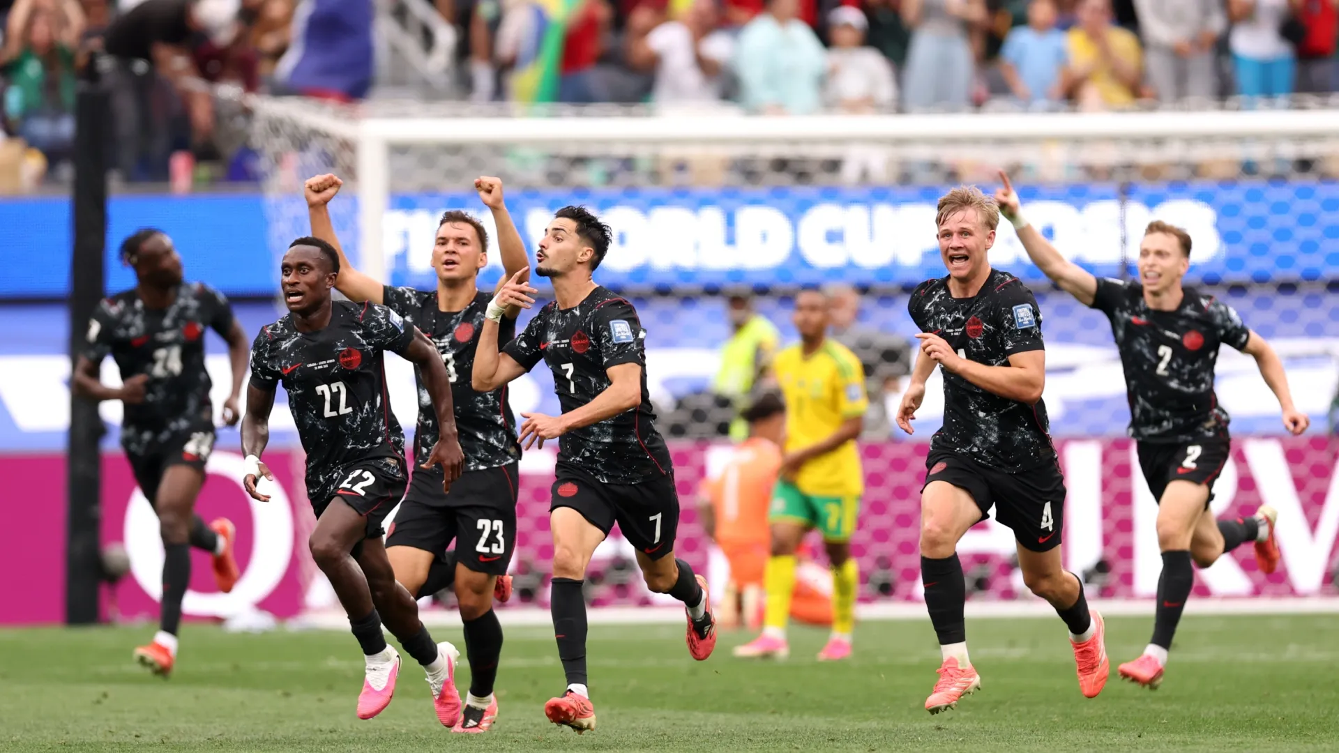 Canada celebrate their late winner.