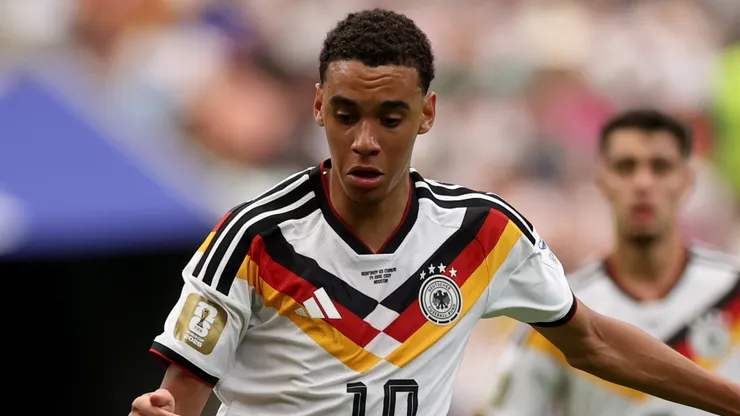 Jamal Musiala #10 of Germany runs with the ball.