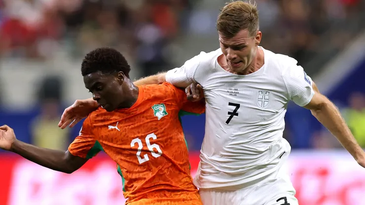 Christ Inao Oulai #26 of Cote d'Ivoire competes for the ball against Alexander Sorloth #7 of Norway.