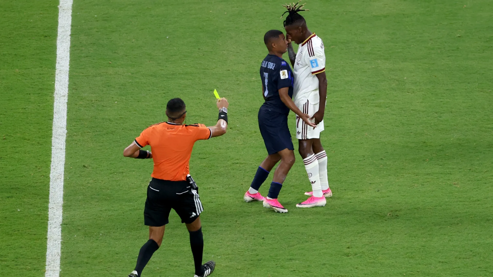 Nicolas de la Cruz of Uruguay receives a yellow card after his challenged on Nico Williams. Luke Hales/Getty Images