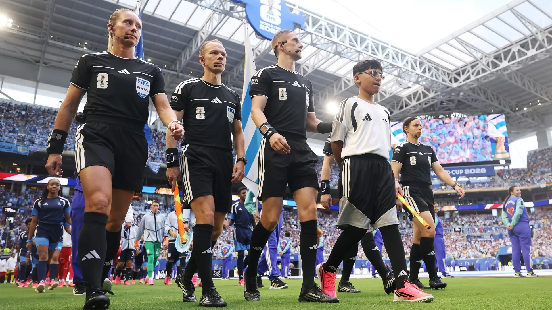 Referee Espen Eskas walks onto the pitch with match official. Baron/Getty Images