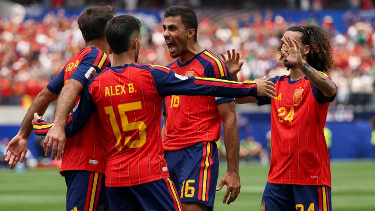 Mikel Oyarzabal #21 of Spain celebrates with teammates.