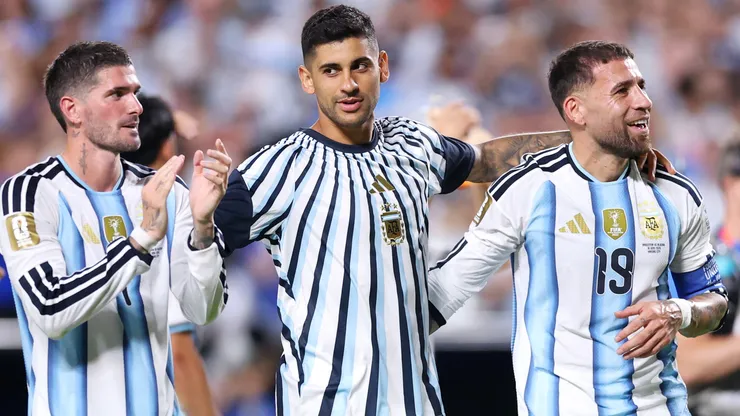 Rodrigo De Paul #7, Cristian Romero #13 and Nicolas Otamendi #19 of Argentina applaud fans.