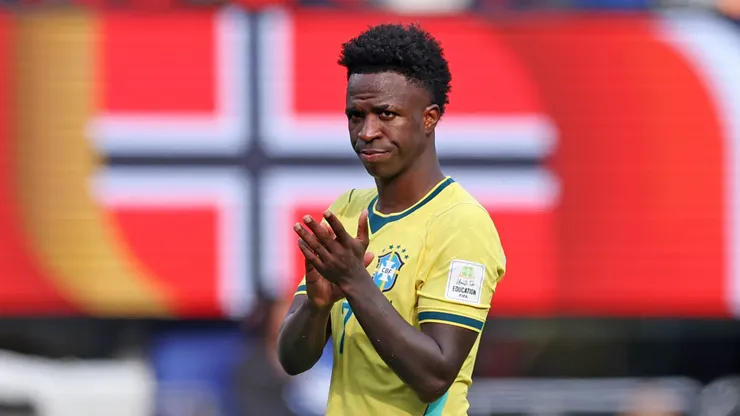 Vinicius Jr. walks off the pitch after Brazil elimination.