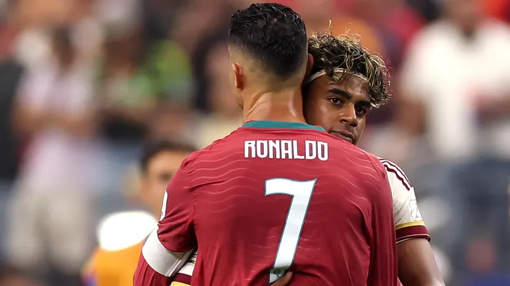 Cristiano Ronaldo #7 of Portugal congratulates Lamine Yamal #19 of Spain.