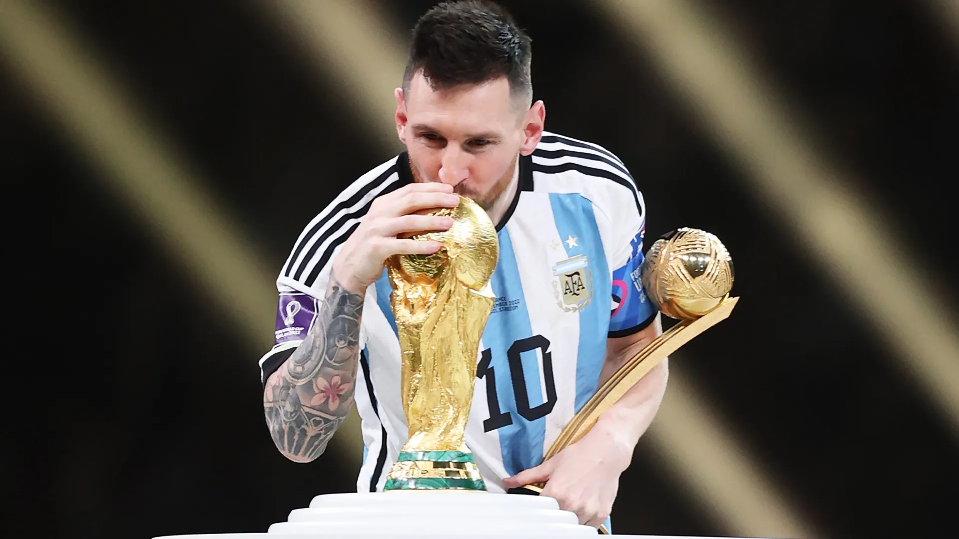 Lionel Messi of Argentina kisses the FIFA World Cup Qatar 2022 Winners’ Trophy. Julian Finney/Getty Images