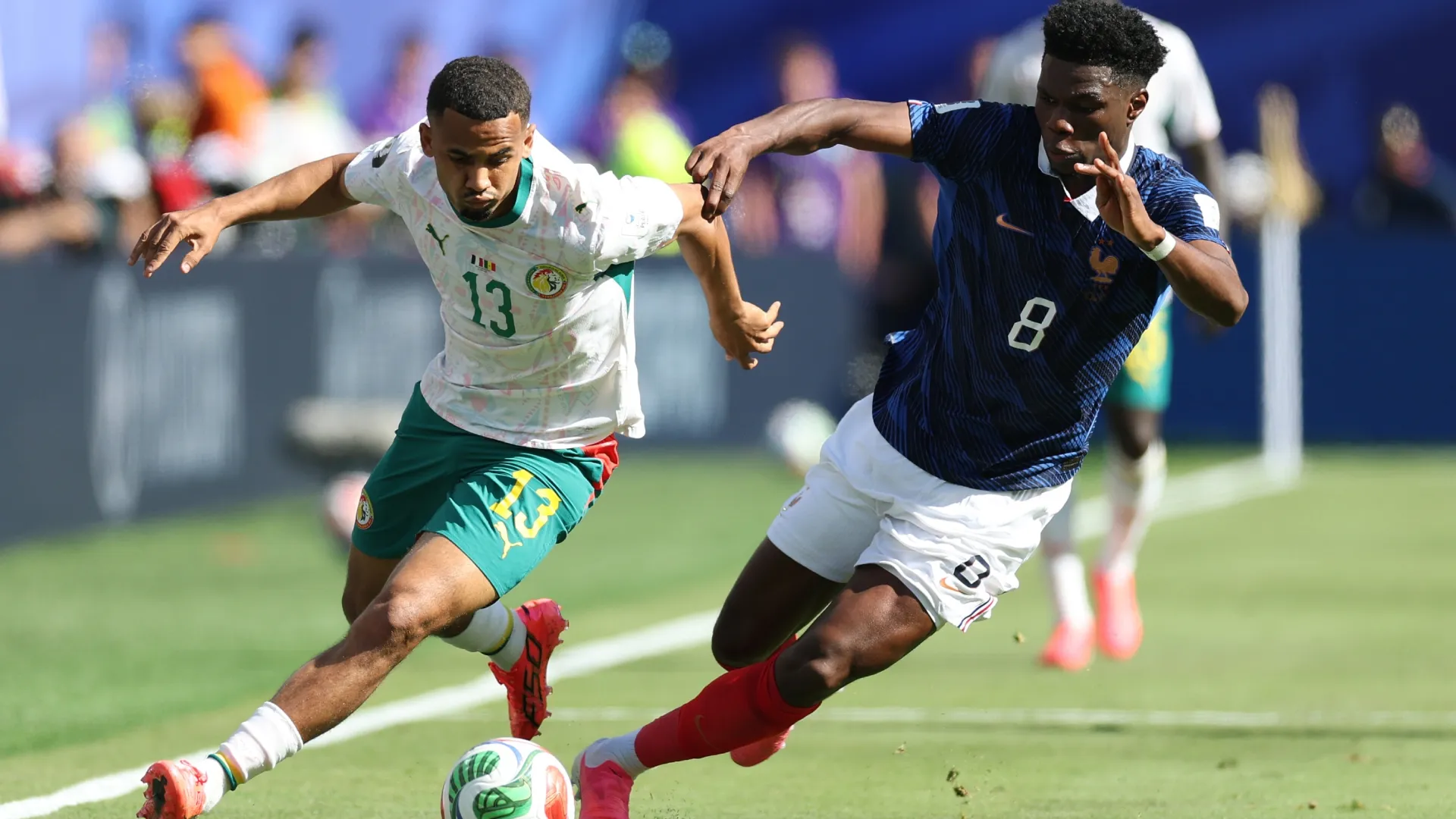 Iliman Ndiaye #13 of Senegal controls the ball against Aurélien Tchouaméni #8 of France. Al Bello/Getty Images