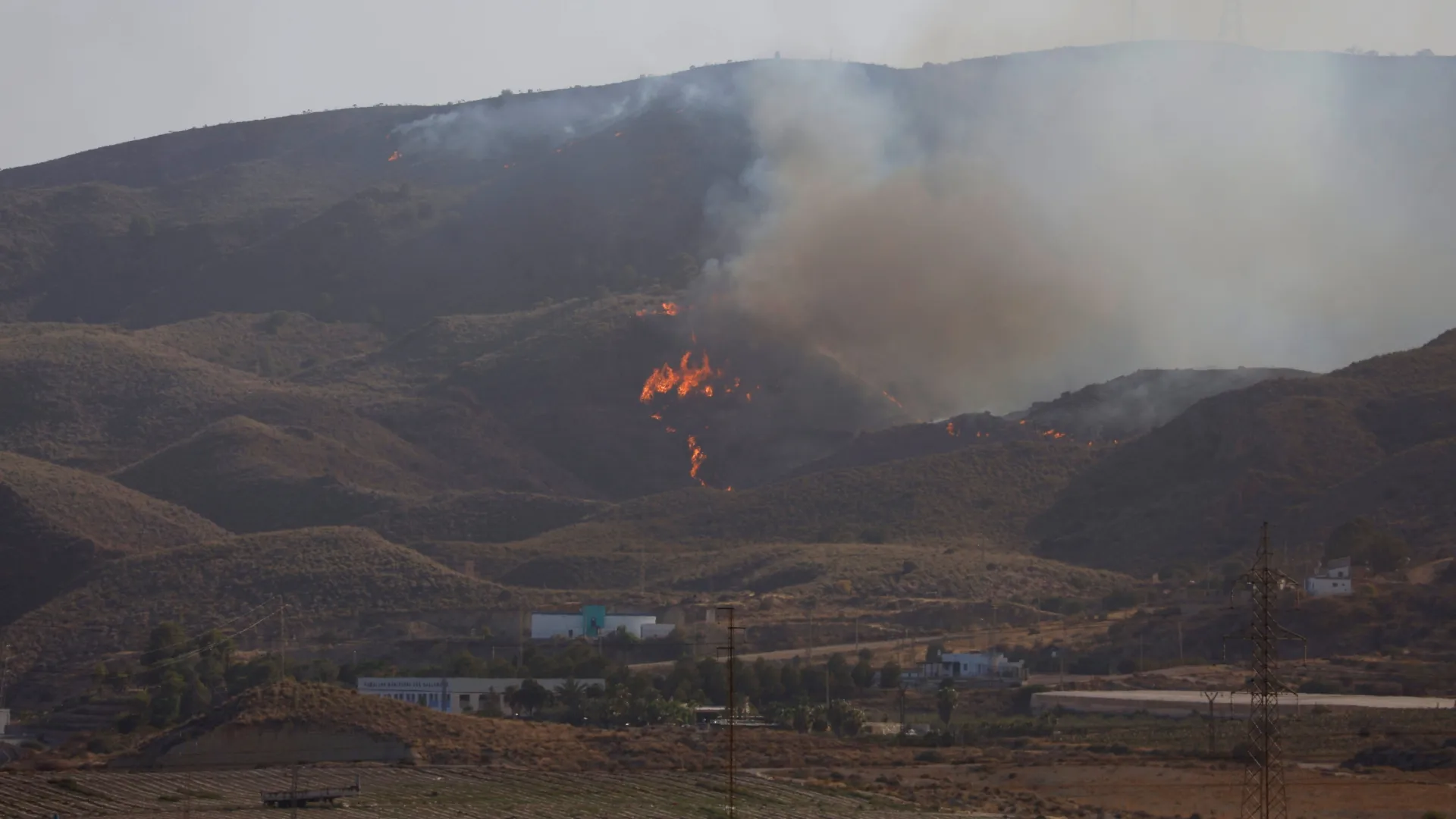 Flames and Smoke rise from a wildfire