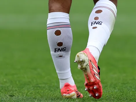 Why do some soccer players have holes in their socks?