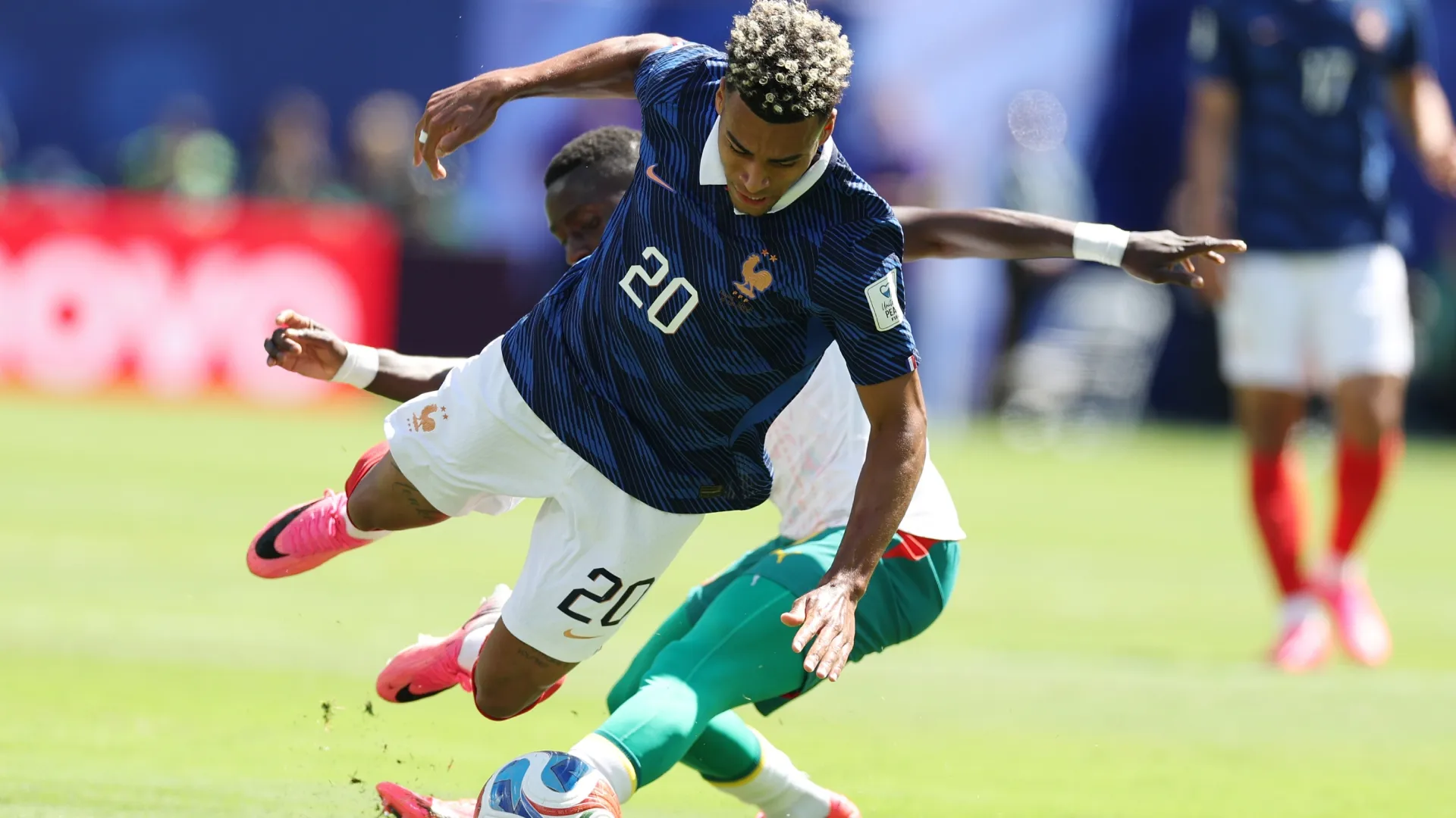 Desire Doue #20 of France is tackled during the FIFA World Cup 2026 match. AI Bello/Getty Images