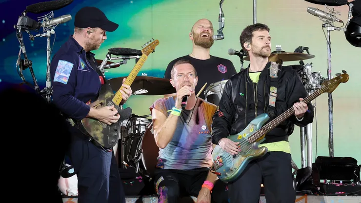 Jonny Buckland, Chris Martin, Will Champion and Guy Berryman of Coldplay perform onstage at Rose Bowl Stadium