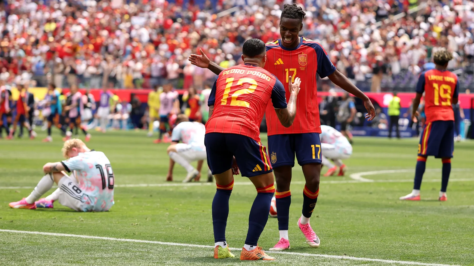 Nico Williams #17 and Pedro Porro #12 of Spain celebrate after the win. by Florencia Tan Jun/Getty Images