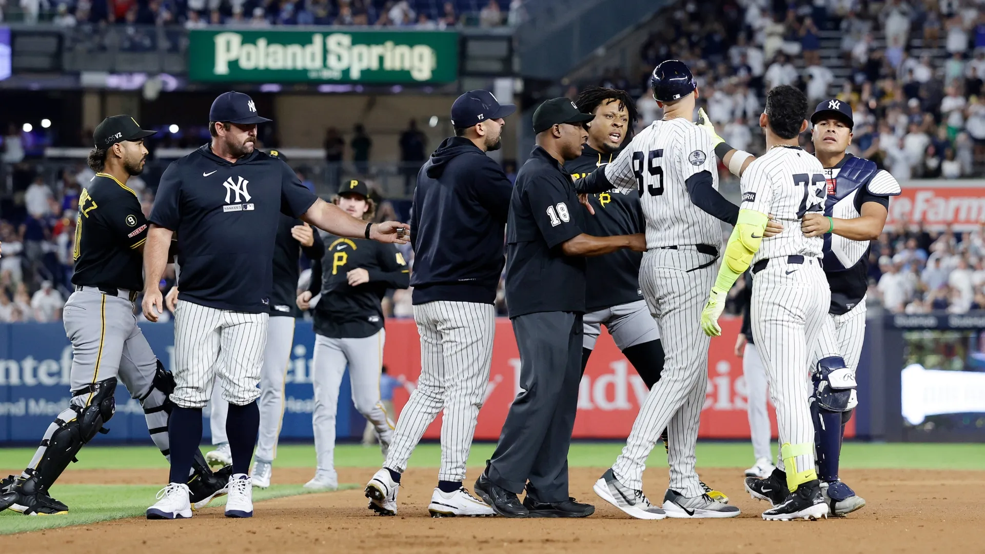 Jose Caballero #72 of the Yankees is restrained after an altercation against the Pirates. Jim McIsaac/Getty Images