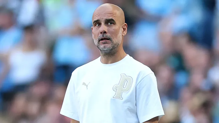 Pep Guardiola, Manager of Manchester City, looks on.