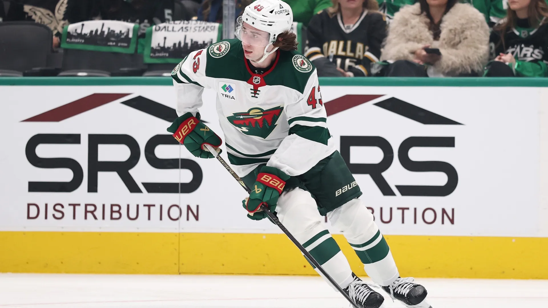 Quinn Hughes #43 of the Wild controls the puck. Stacy Revere/Getty Images