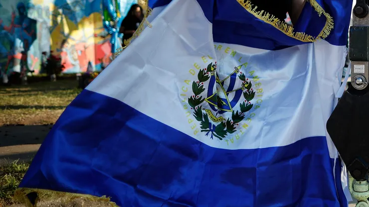 Fans holds the flag of El Salvador