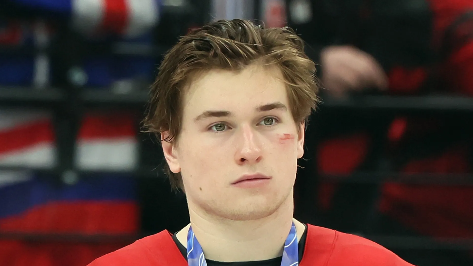 Macklin Celebrini #17 of Team Canada stands with his silver medal following the Men's Gold Medal match between Canada and the United States on day 16 of the Milano Cortina 2026 Winter Olympic games at Milano Santagiulia Ice Hockey Arena on February 22, 2026 in Milan, Italy. The United States defeated Canada 2-1 in overtime.