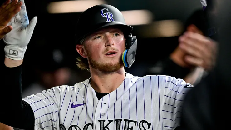 Hunter Goodman #15 of the Colorado Rockies celebrates after scoring a run.