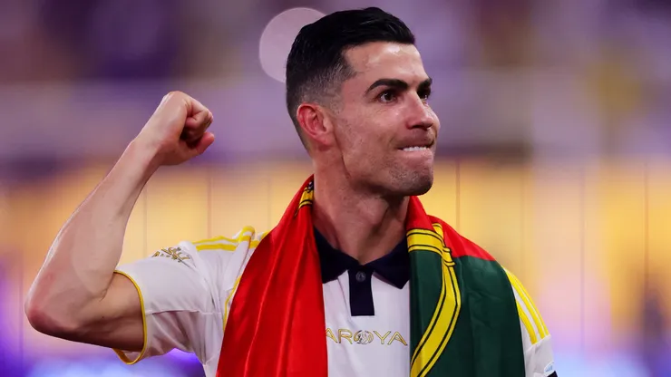 Cristiano Ronaldo of Al Nassr celebrates with a Portuguese flag.