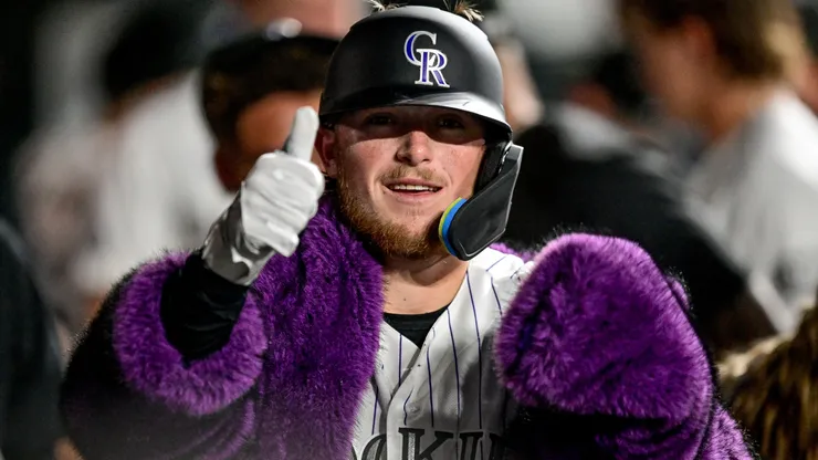 Hunter Goodman #15 of the Colorado Rockies celebrates in the dugout.