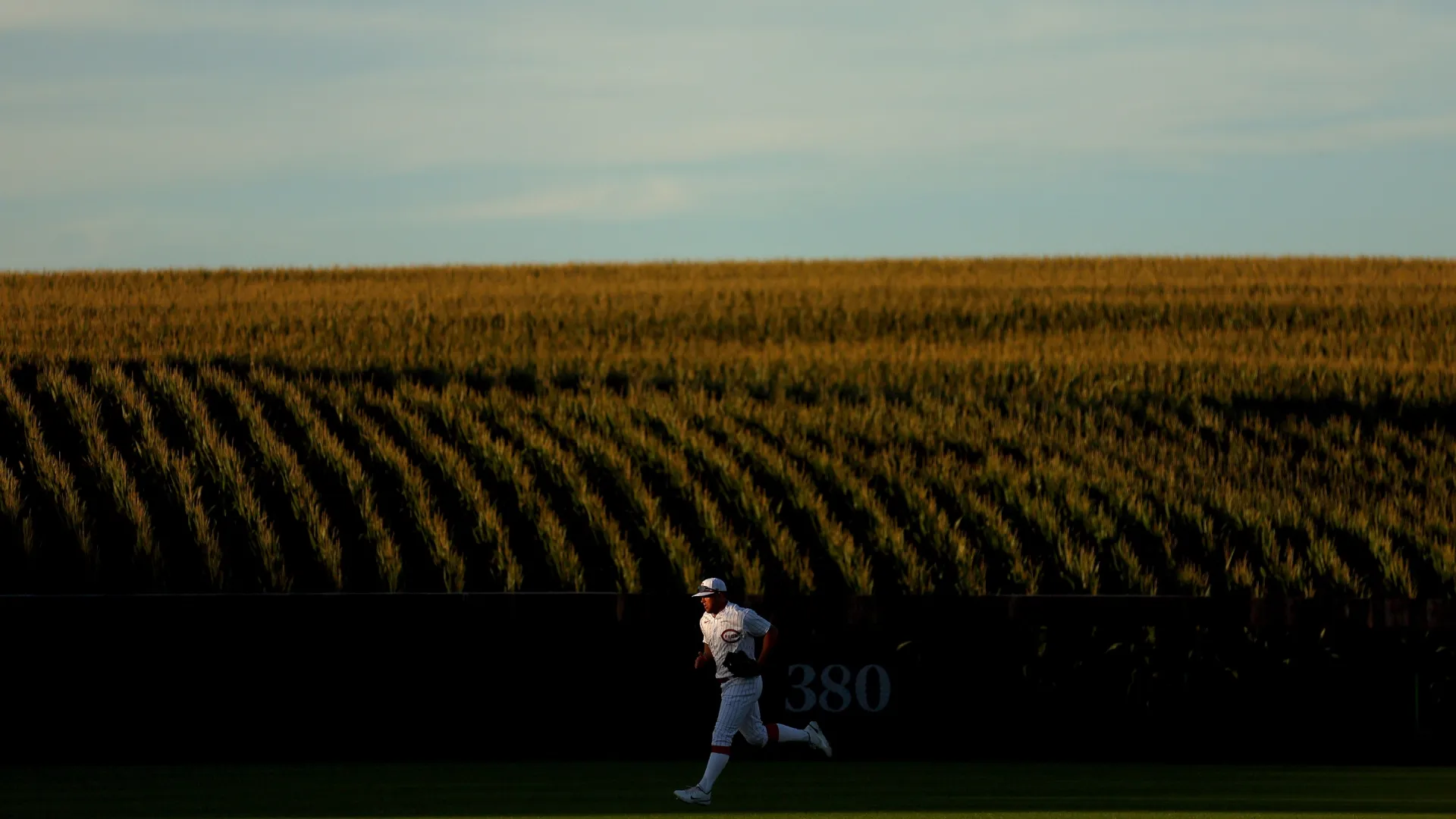 Nick Senzel #15 of the Reds runs to the dugout at Field of Dreams in 2022 (Source: Michael Reaves/Getty Images)