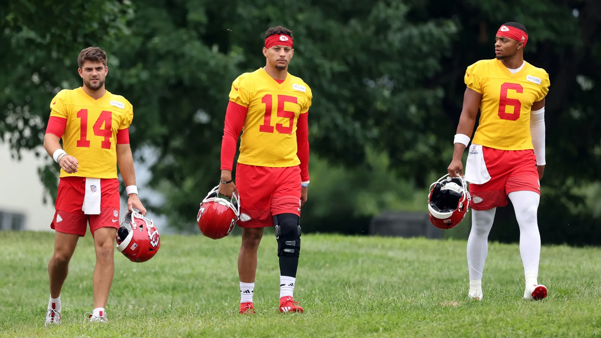 Garrett Nussmeier, Patrick Mahomes and Justin Fields walk toward the practice field during Kansas City Chiefs training camp (Source: Jamie Squire/Getty Images)