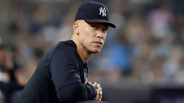 Aaron Judge #99 of the New York Yankees looks on from the dugout.
