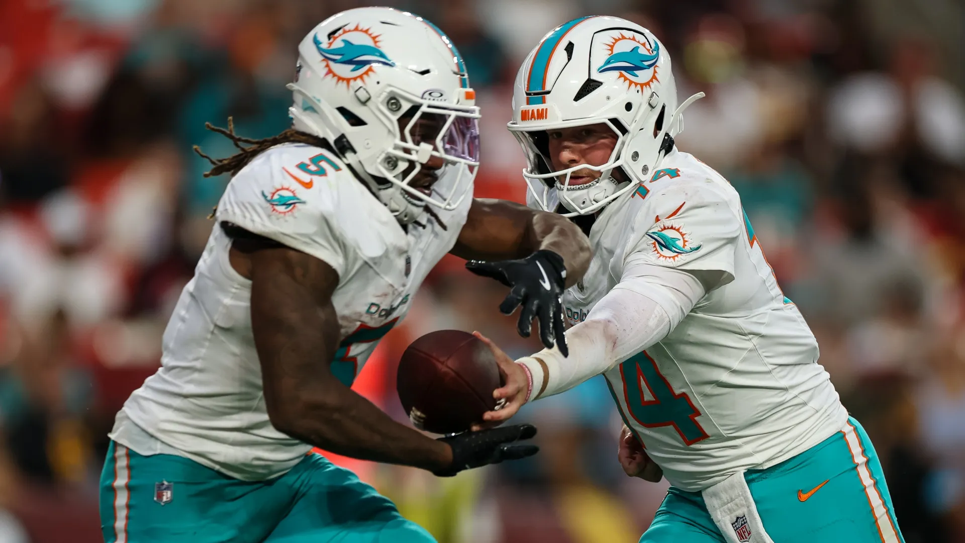 Quinn Ewers #14 of the Miami Dolphins hands the ball off to Jaylen Wright #5 (Source: Scott Taetsch/Getty Images)