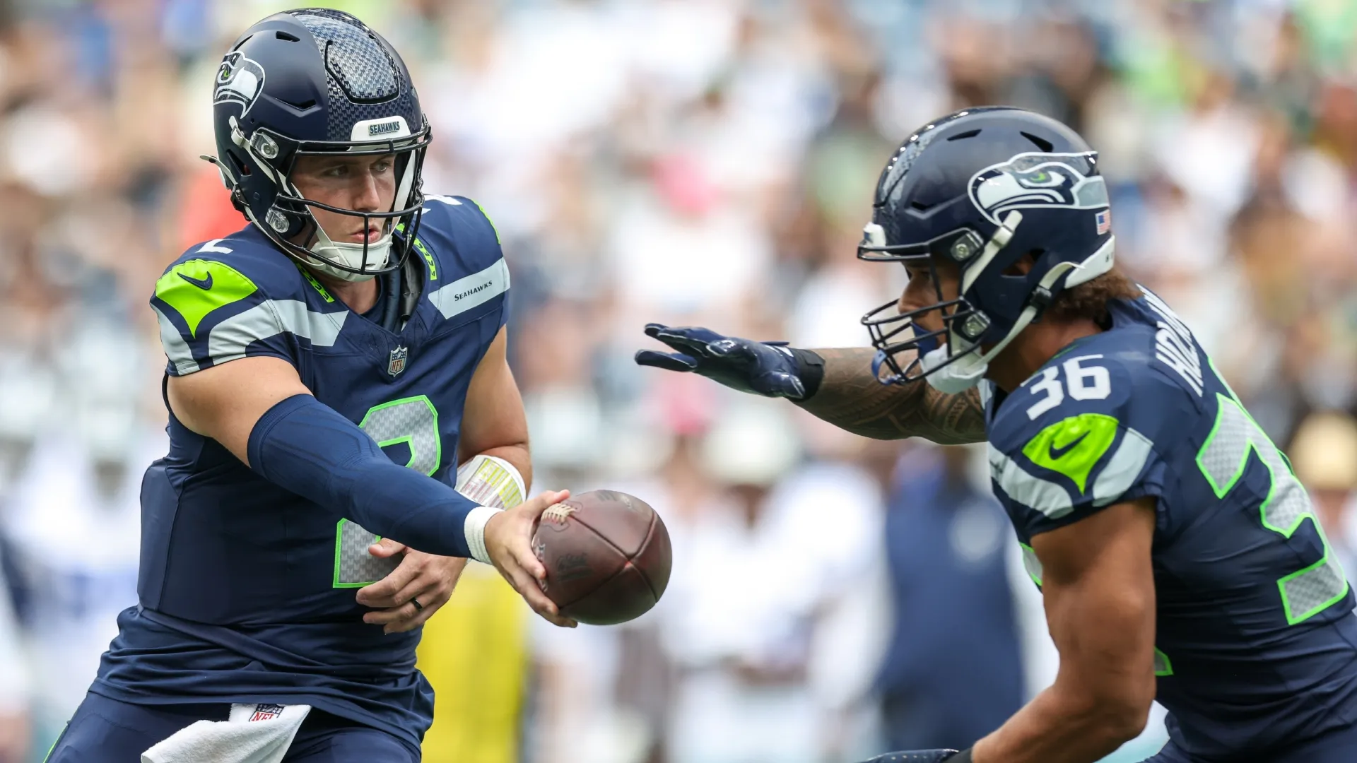 Drew Lock #2 of the Seattle Seahawks hands the ball off to George Holani #36 (Source: Jack Compton/Getty Images)