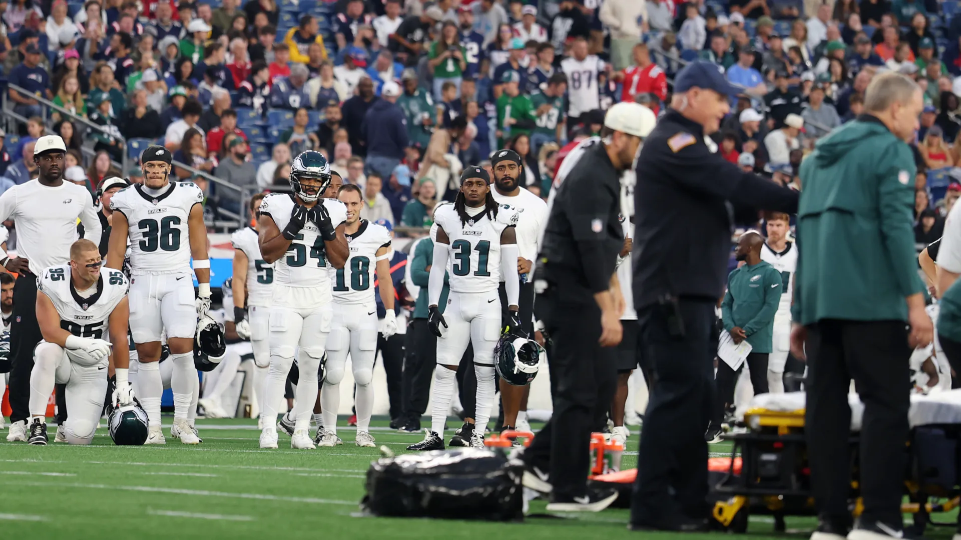 Members of the Philadelphia Eagles gather around their injured teammate Ja'quinden Jackson.