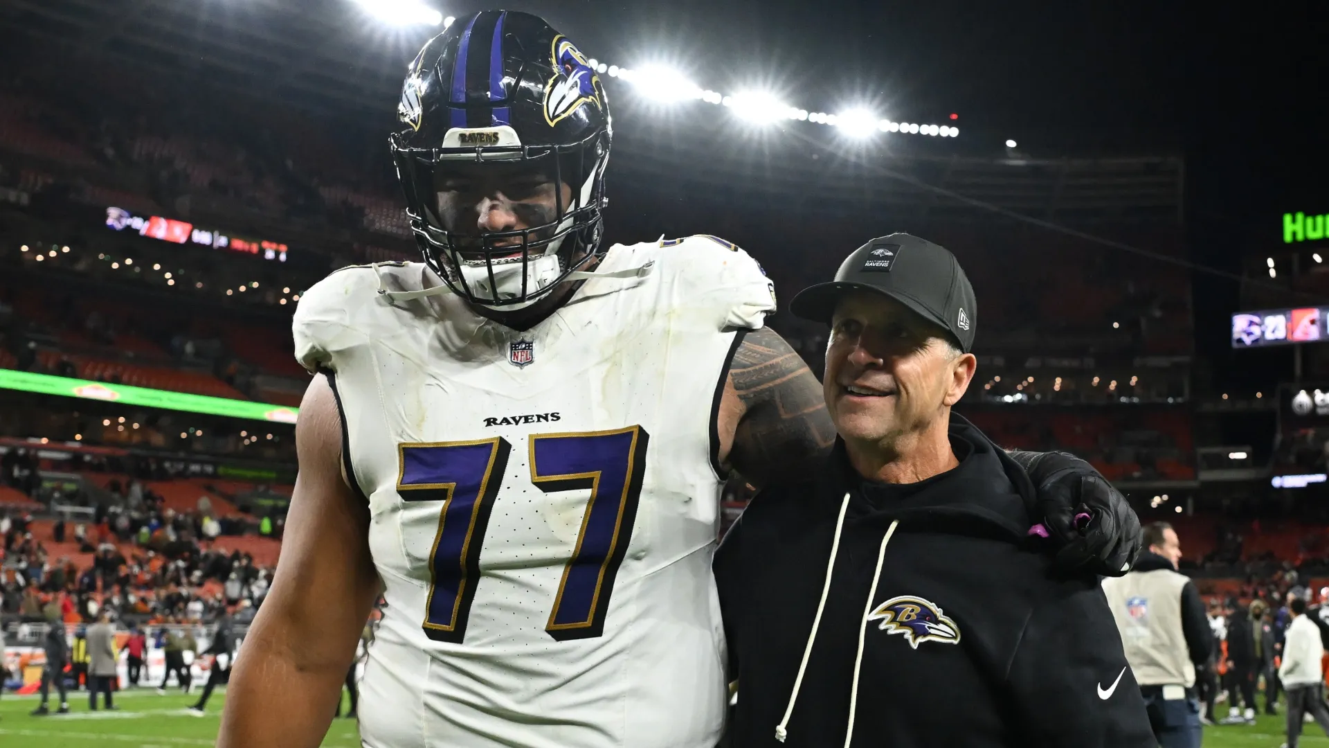 John Harbaugh with Daniel Faalele