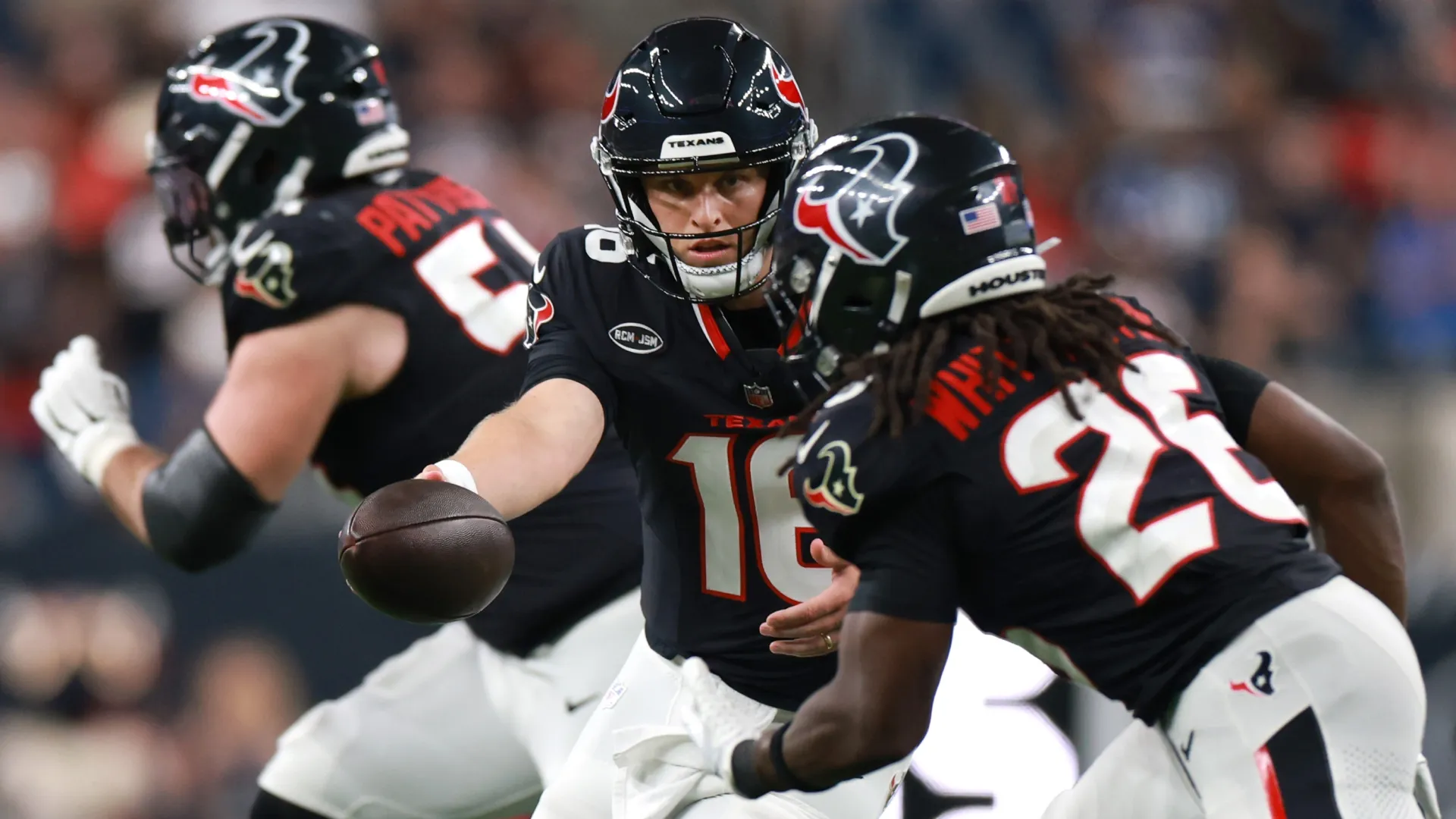 Brett Rypien #16 of the Houston Texans hands the ball to Noah Whittington #26 (Source: Kenneth Richmond/Getty Images)