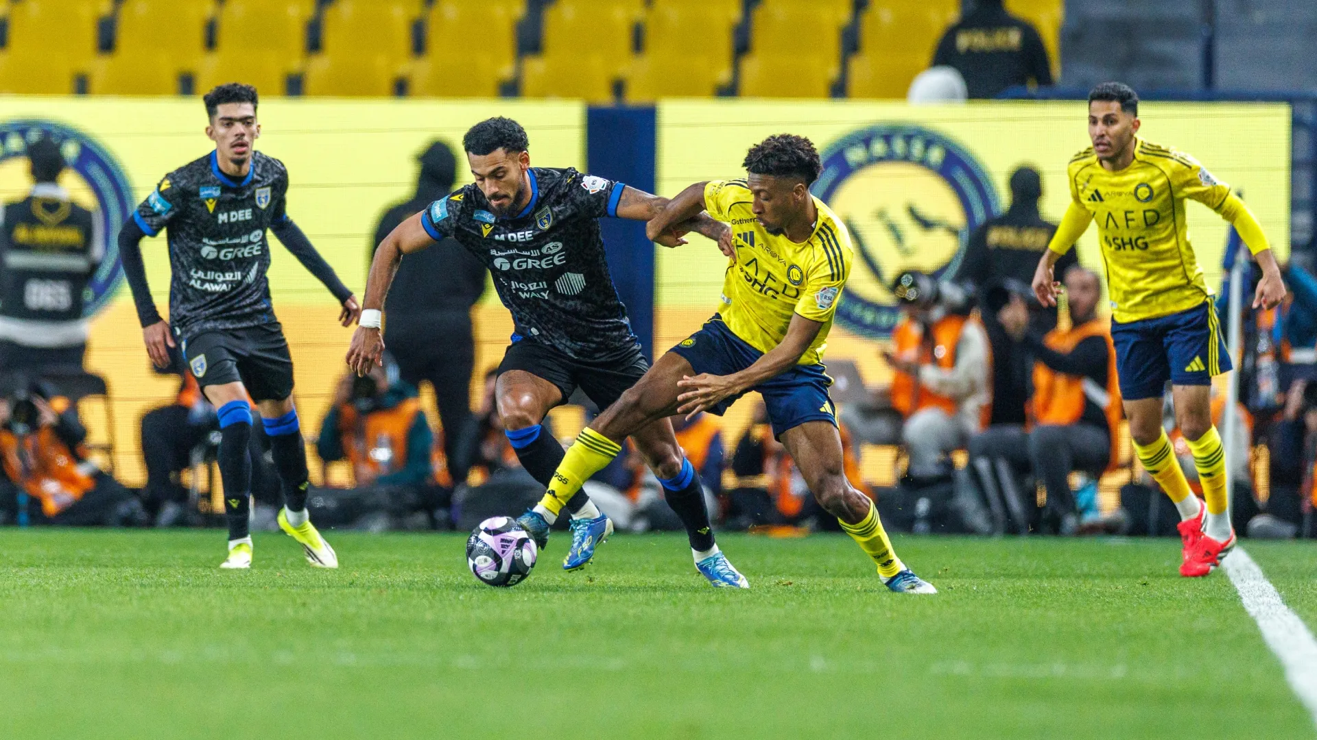 Kingsley Coman of Al-Nassr while under pressure Angelo Fulgini of team Al-Taawoun (Source: Abdullah Ahmed/Getty Images)