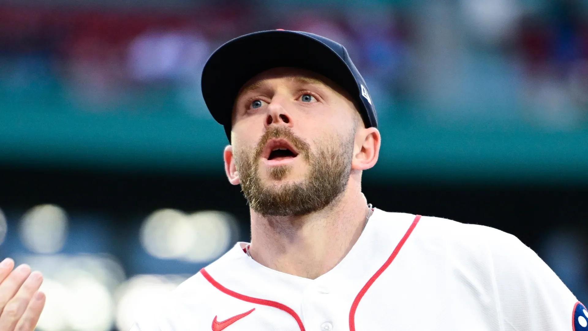 Trevor Story #10 of the Boston Red Sox tosses a ball to a fan between innings during a game against the Philadelphia Phillies at Fenway Park on May 13, 2026 in Boston, Massachusetts.
