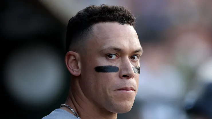 Aaron Judge #99 of the New York Yankees standing in the dugout.