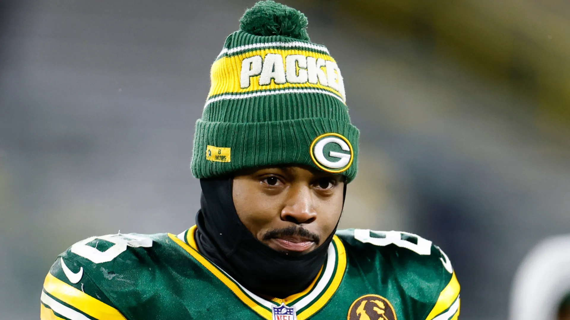Josh Jacobs #8 of the Green Bay Packers walks off the field with turkey after defeating the Miami Dolphins 30-17 at Lambeau Field on November 28, 2024 in Green Bay, Wisconsin.