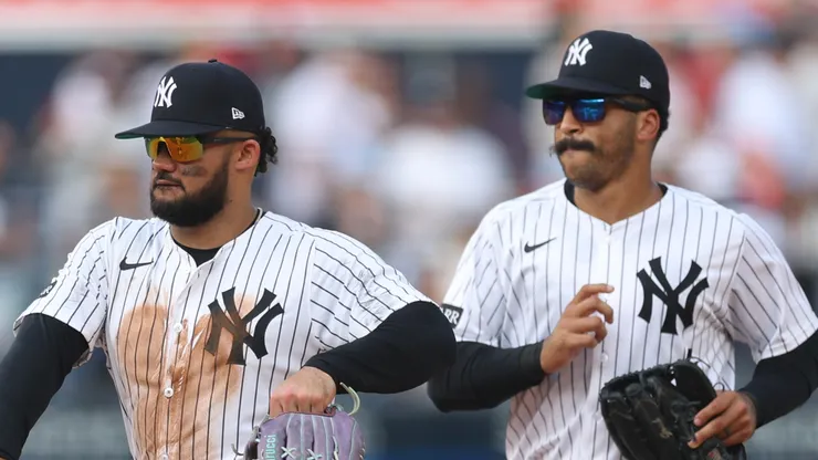 Jasson Domínguez #24 and Trent Grisham #12 of the New York Yankees.