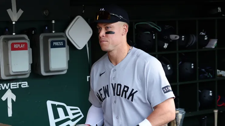 Aaron Judge #99 of the New York Yankees stands in the dugout.