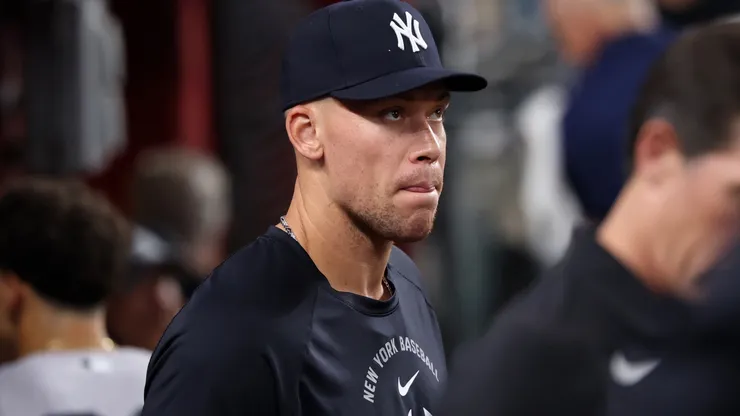 Aaron Judge #99 of the New York Yankees stands in the dugout.