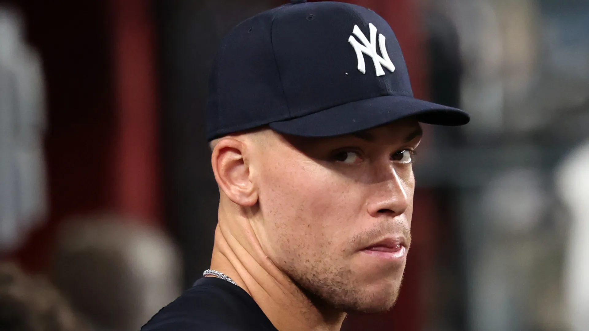 Aaron Judge #99 of the New York Yankees stands in the dugout during the fifth inning of the game against the Arizona Diamondbacks at Chase Field on September 18, 2026 in Phoenix, Arizona.