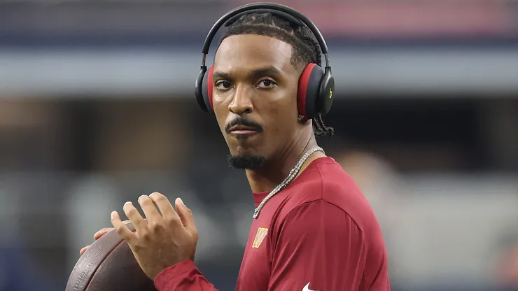 Jayden Daniels #5 of the Washington Commanders participates in warmups prior to a game against the Dallas Cowboys.
