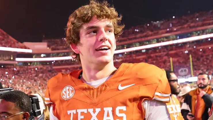Arch Manning #16 of the Texas Longhorns walks off the field after beating the Texas A&M Aggies.