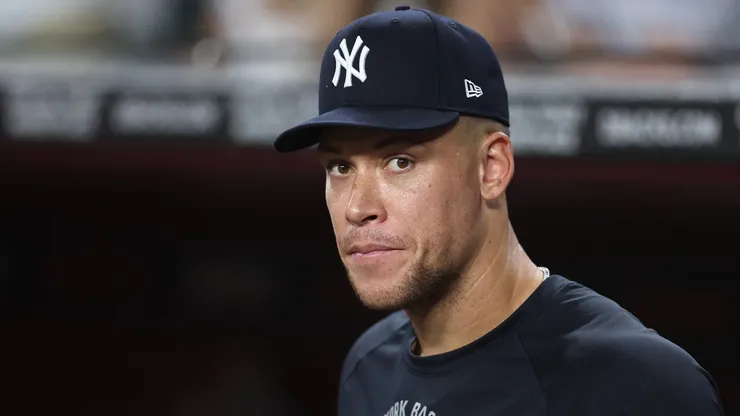 Aaron Judge #99 of the New York Yankees looks on from the dugout .