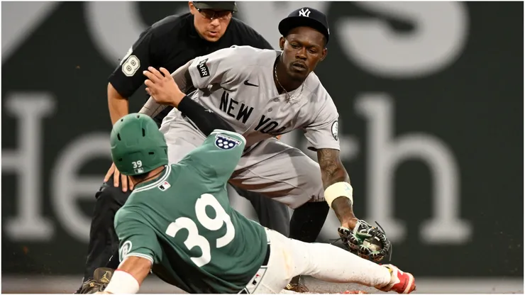 Jazz Chisholm Jr. #13 of the New York Yankees catches Tsung-Che Cheng of the Boston Red Sox stealing second base.
